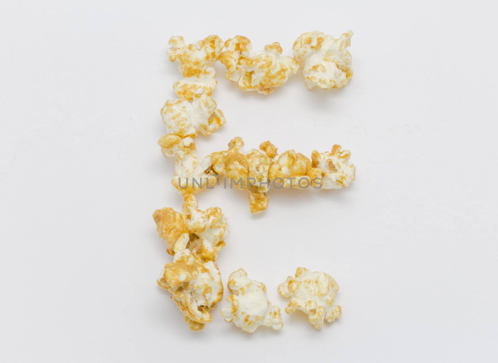 pop corn forming letter E isolated on white background by chingraph