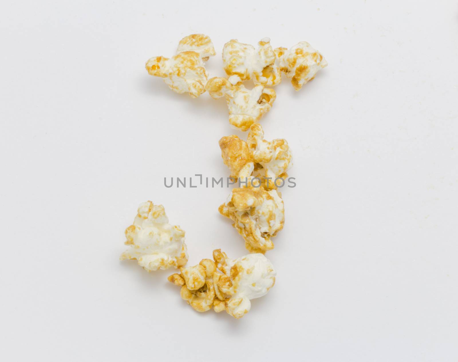pop corn forming letter J isolated on white background by chingraph