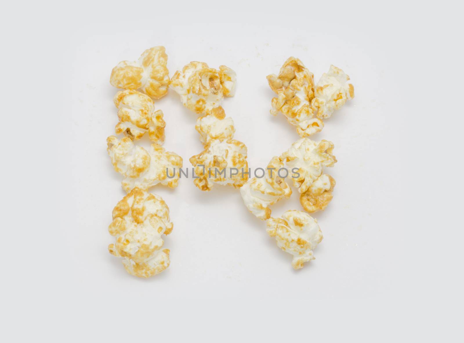 pop corn forming letter N isolated on white background by chingraph