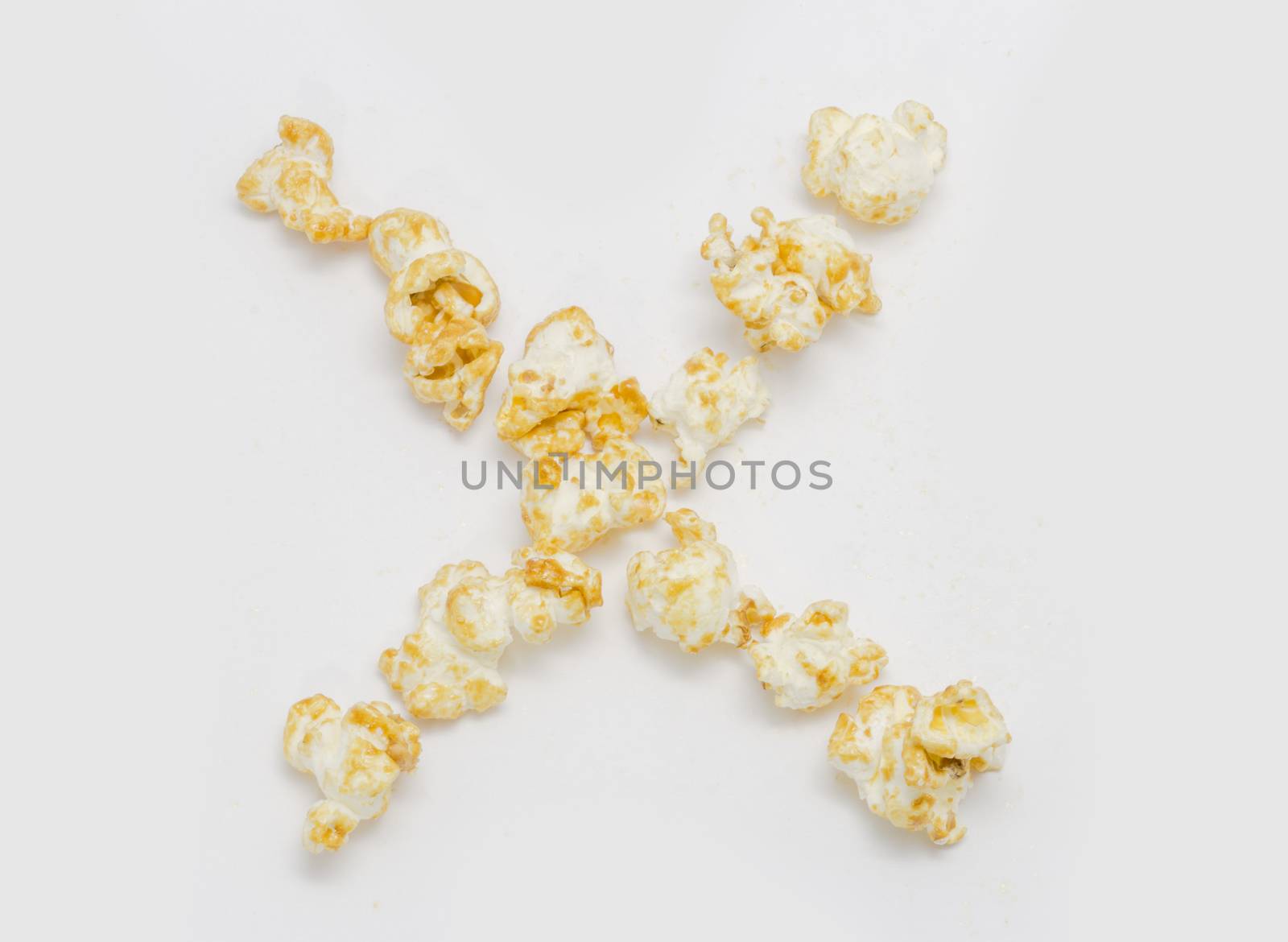 pop corn forming letter X isolated on white background