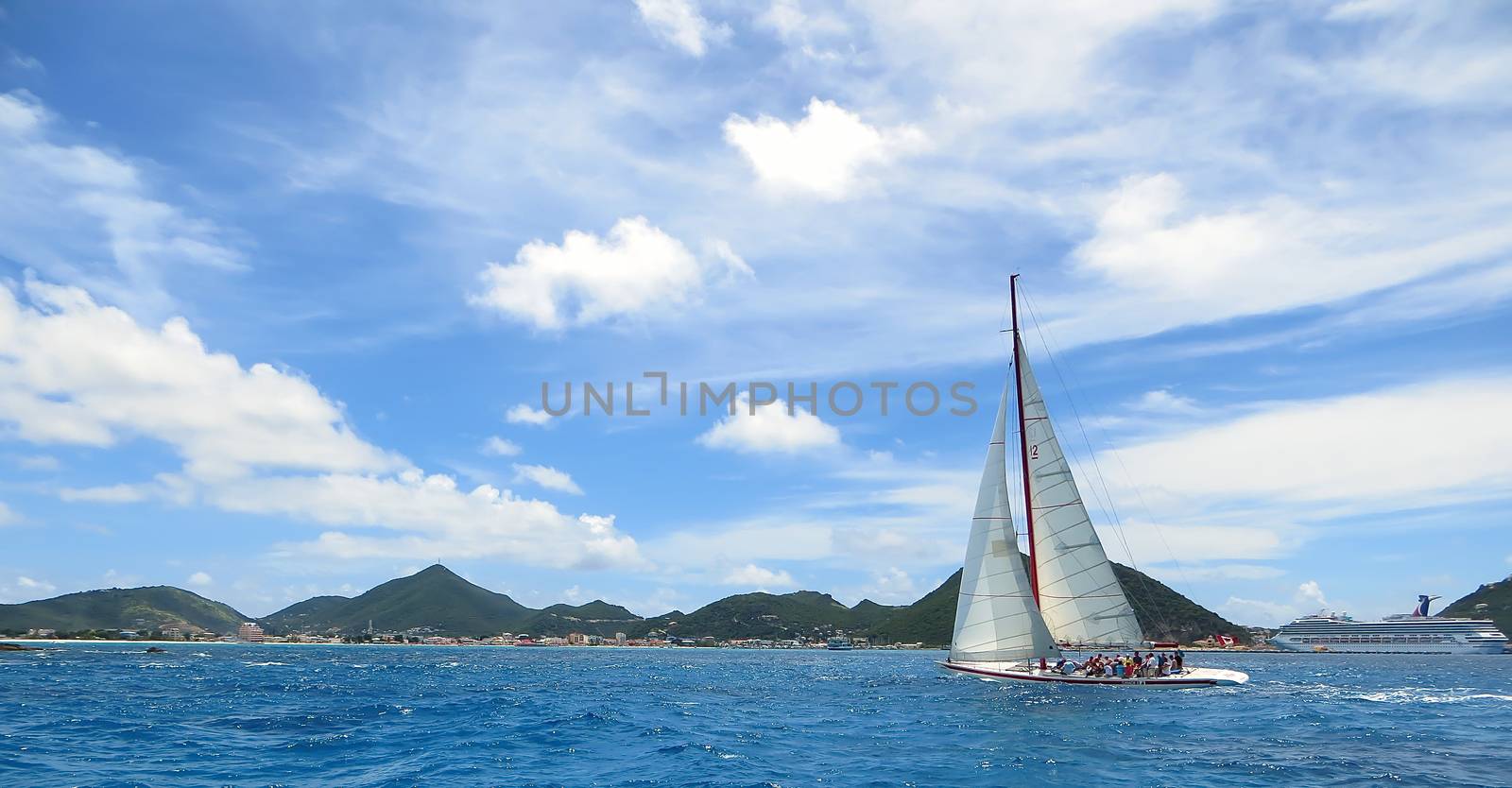 Great Bay, St. Maarten, Netherlands Antilles-June 22, 2013: Former America's Cup yacht, Canada 2, picks up wind and gives the the tourists and crew a thrilling cruise off the coast.