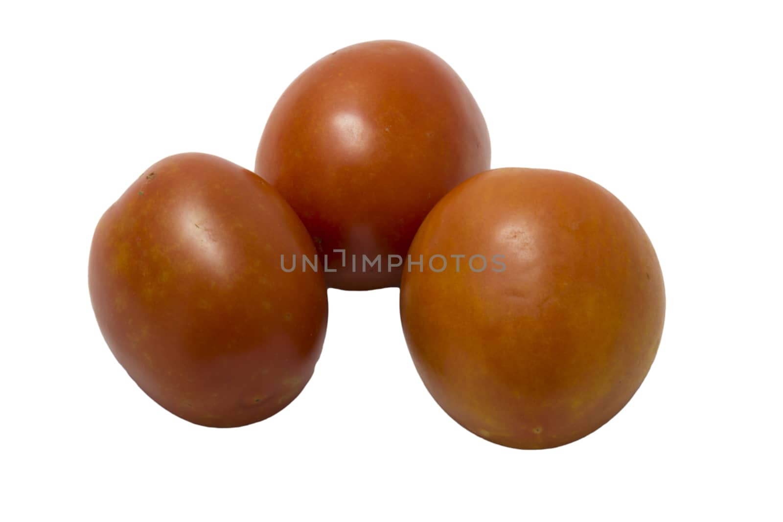 three fresh tomatoes with green leaves isolated on white background