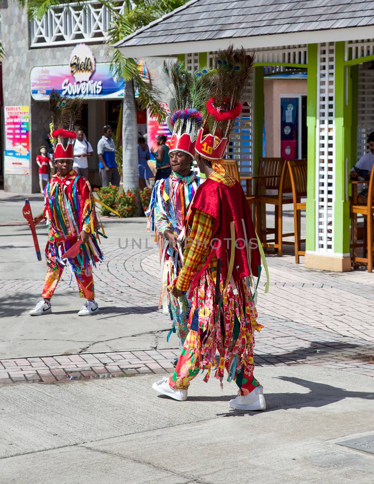 Basseterre, Saint Kitts and Nevis- June 21, 2013: Colorfully dresses island dancers move to their next performance location on this small Caribbean island nation.