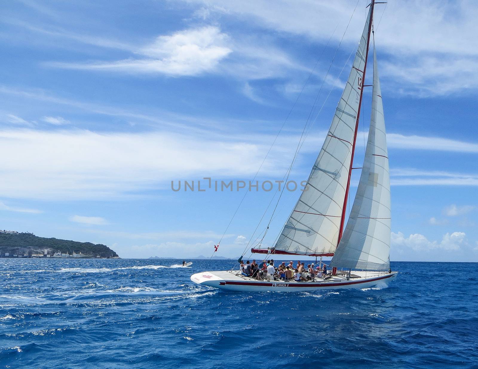 Great Bay, St. Maarten, Netherlands Antilles-June 22, 2013: Former America's Cup yacht, Canada 2, picks up wind and gives the the tourists and crew a thrilling cruise off the coast.