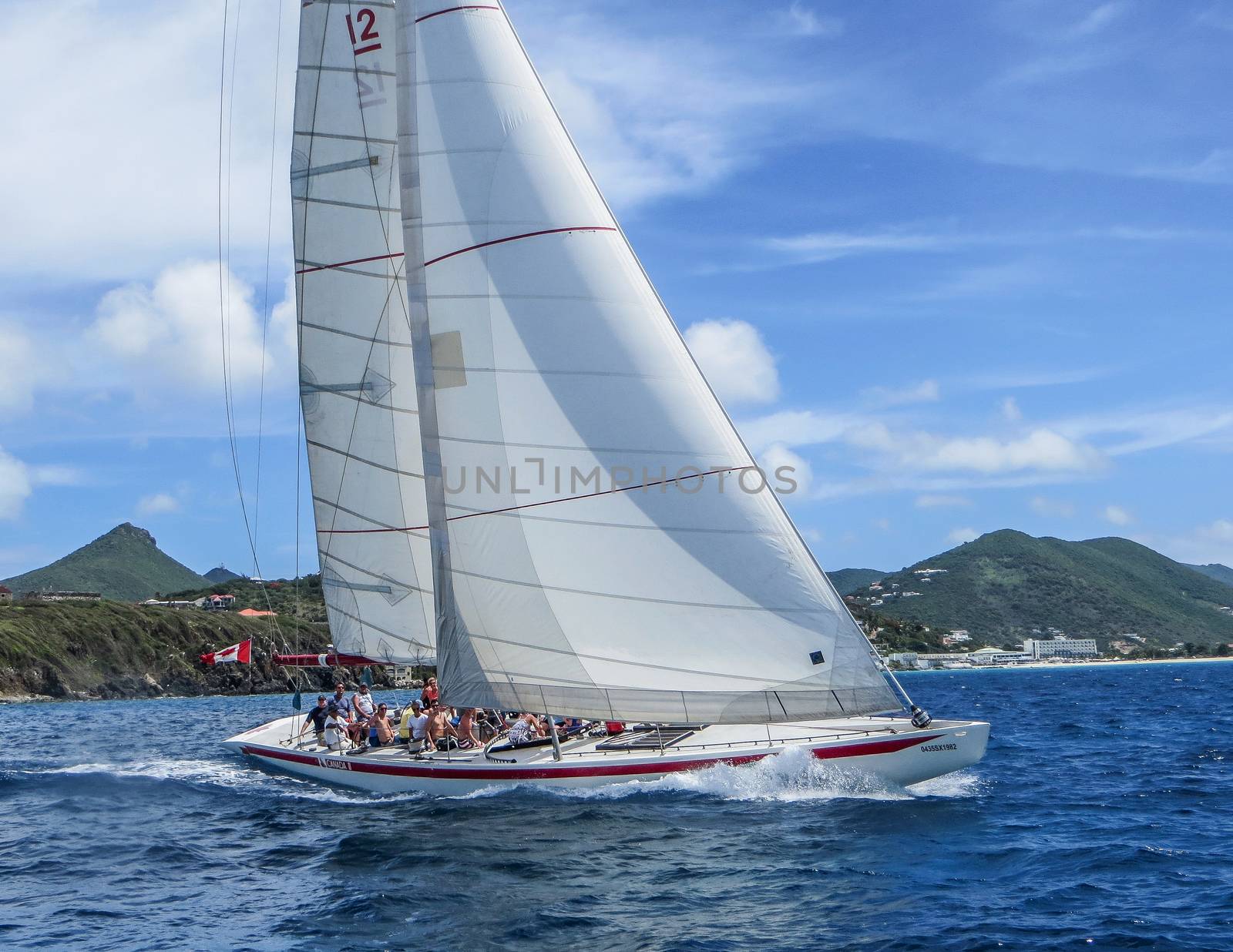 Great Bay, St. Maarten, Netherlands Antilles-June 22, 2013: Former America's Cup yacht, Canada 2, picks up wind and gives the the tourists and crew a thrilling cruise off the coast.