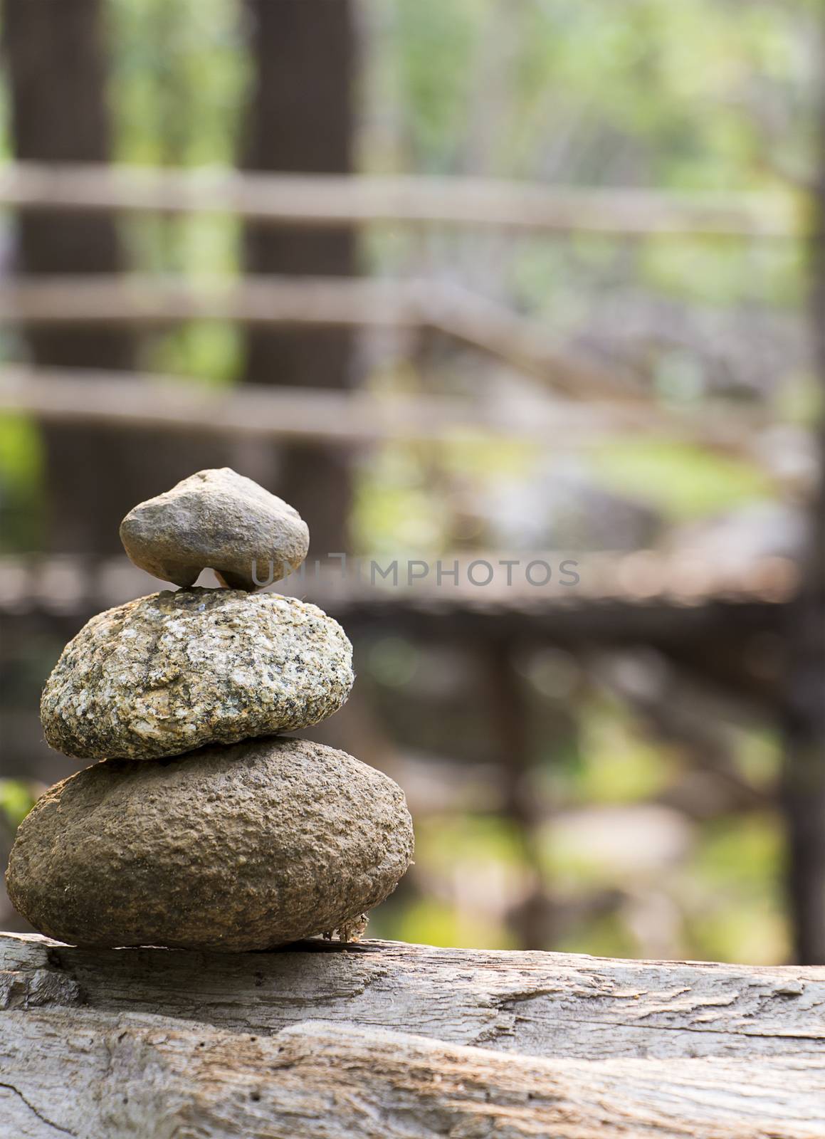 Zen stone with bamboo bridge on background