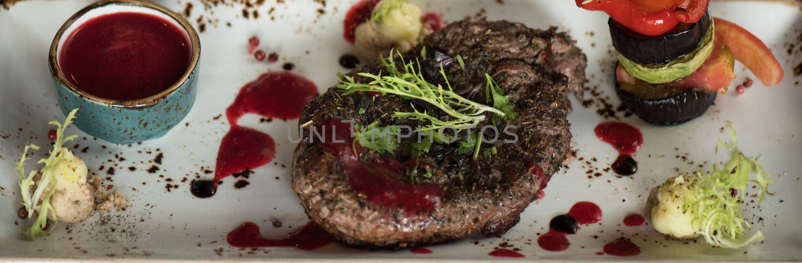 grilled beef steak with herbs vegetables and sauce