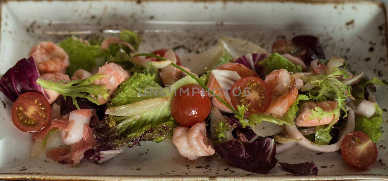 healthy green salad with cooked shrimp and vegetables