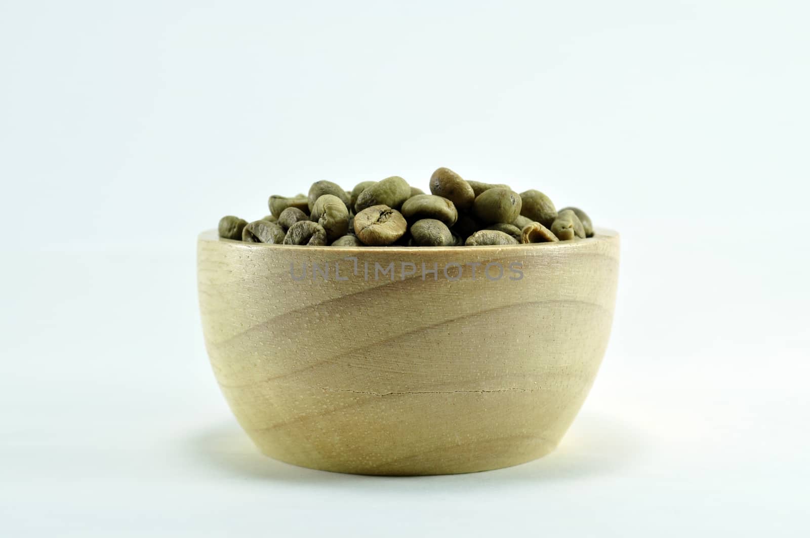 Coffee beans in wooden bowl on white background