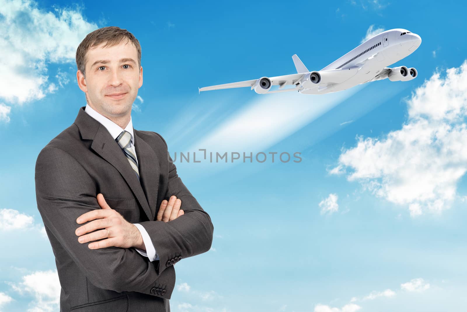 Smilimg businessman looking at camera with jet