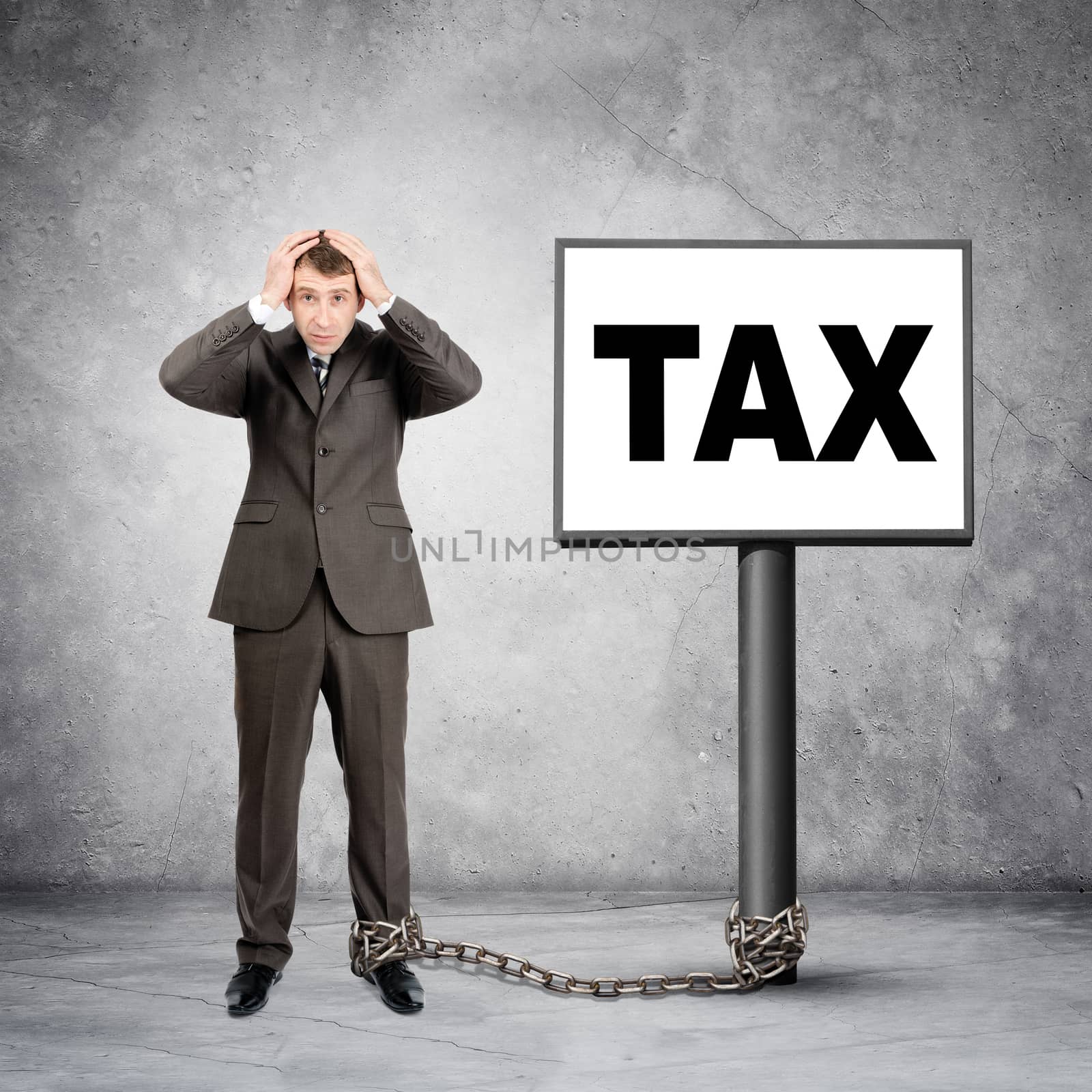 Scared businessman word tax on post sign with chain
