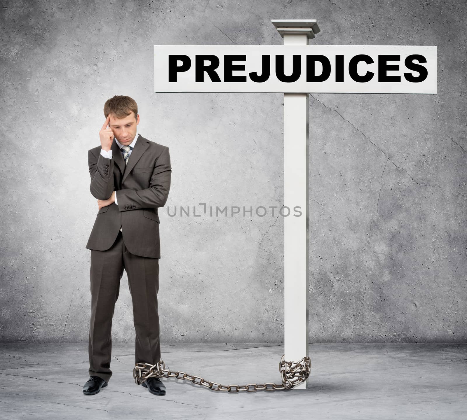 Thinking businessman word prejudice on post sign with chain