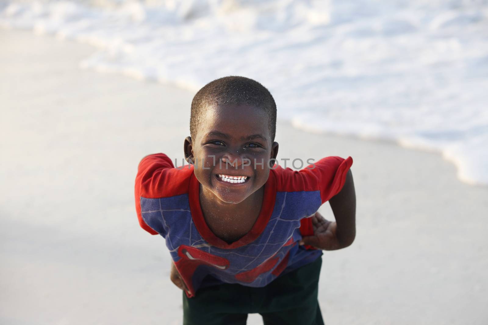 Zanzibar, Tanzania - January 9, 2016: Little cheerful African boy on the beach posing for photos Nungwi. Zanzibar