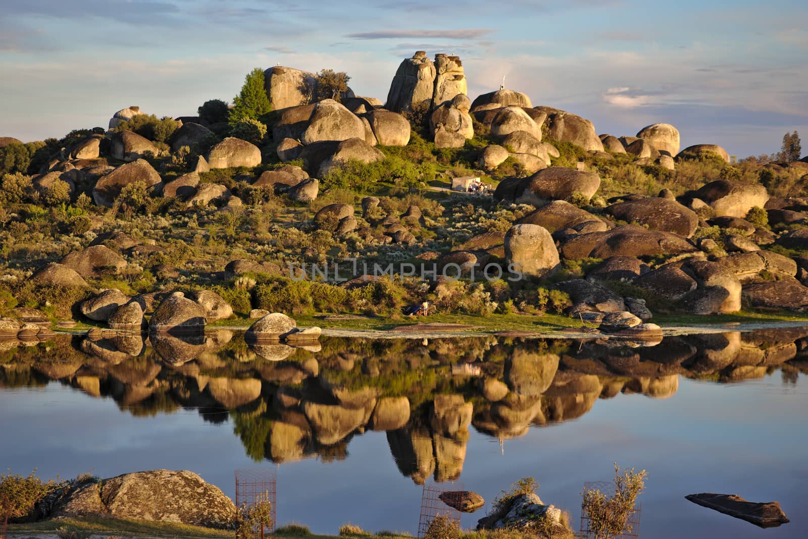 Reflection of big stones over a lake in Los Barruecos, Spain by antecessor