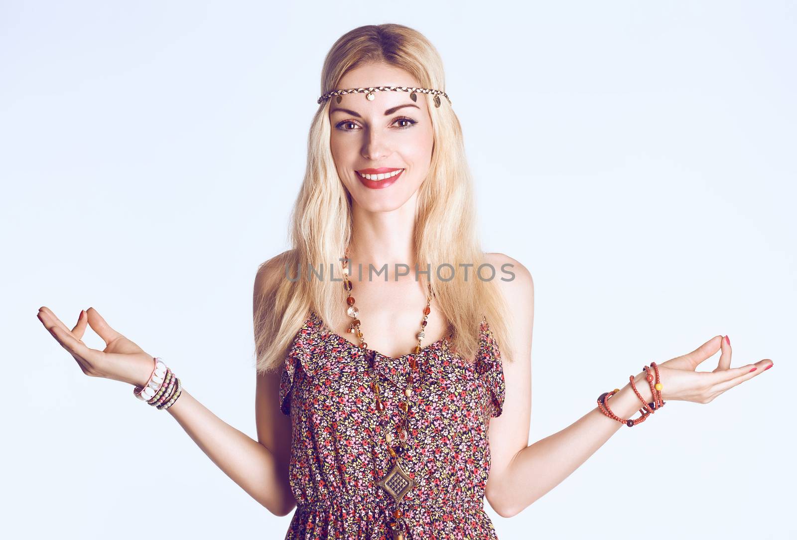 Beauty woman doing yoga, smiling. Boho hippie girl meditates, enjoying calm, relax and harmony, ethnic accessories. Positive blonde, long hair in stylish floral sundress. Unusual creative, people