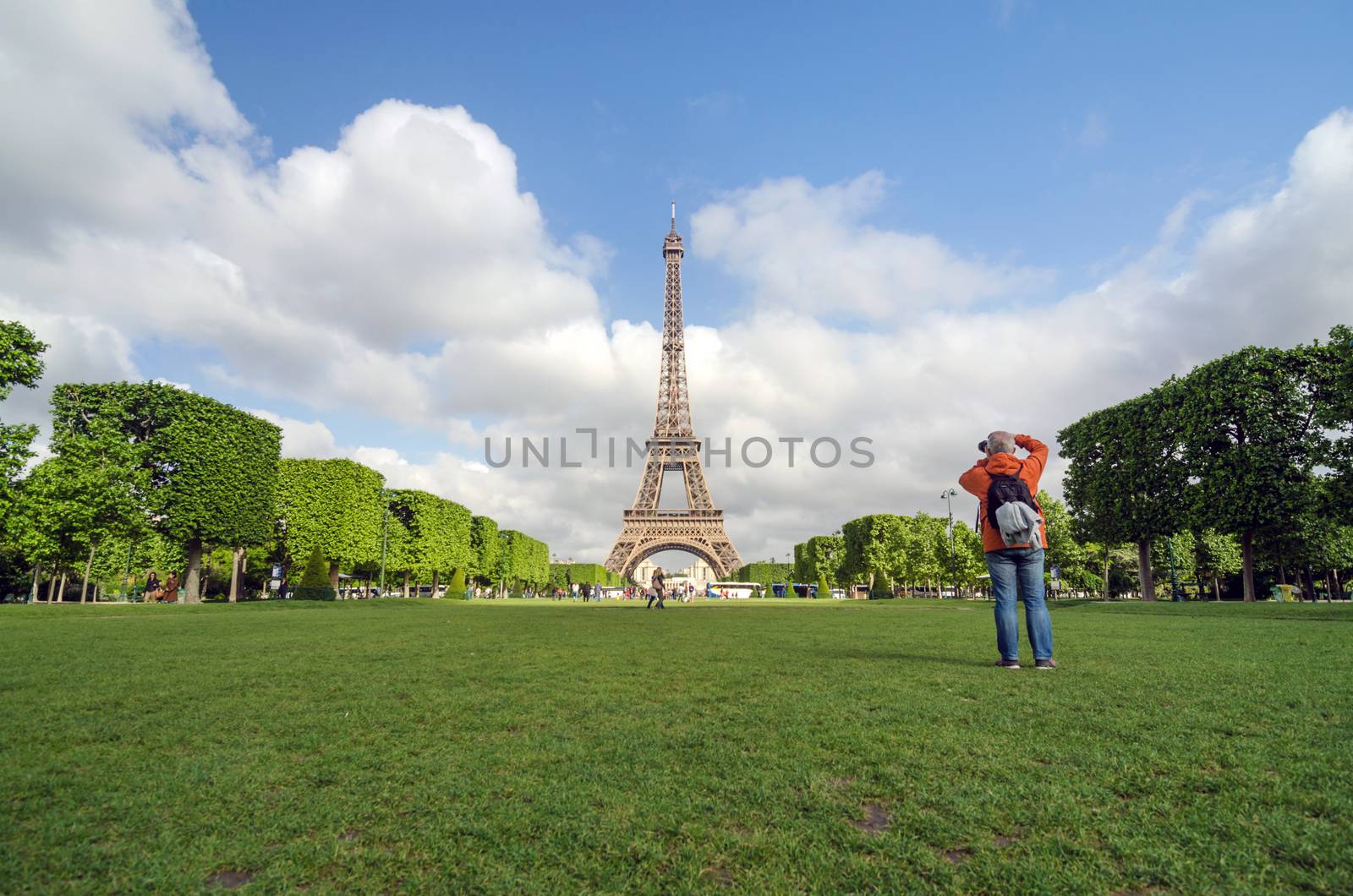 Paris, France - May 15, 2015: People visit the Champs de Mars, at the foot of the Eiffel Tower in Paris. on May 15, 2015.