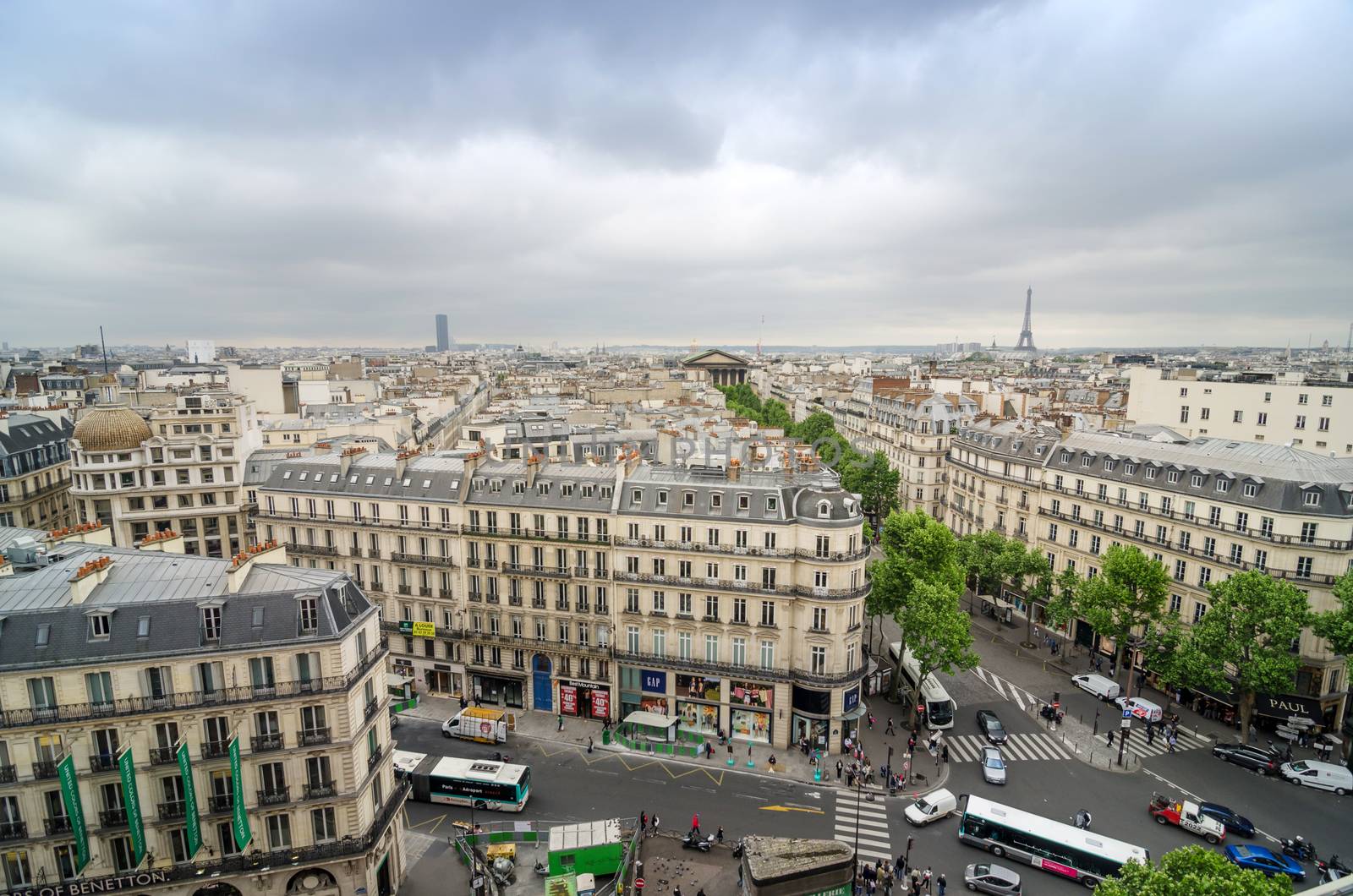 Paris, France - May 15, 2015: People on the street near Madelein Church in Paris by siraanamwong