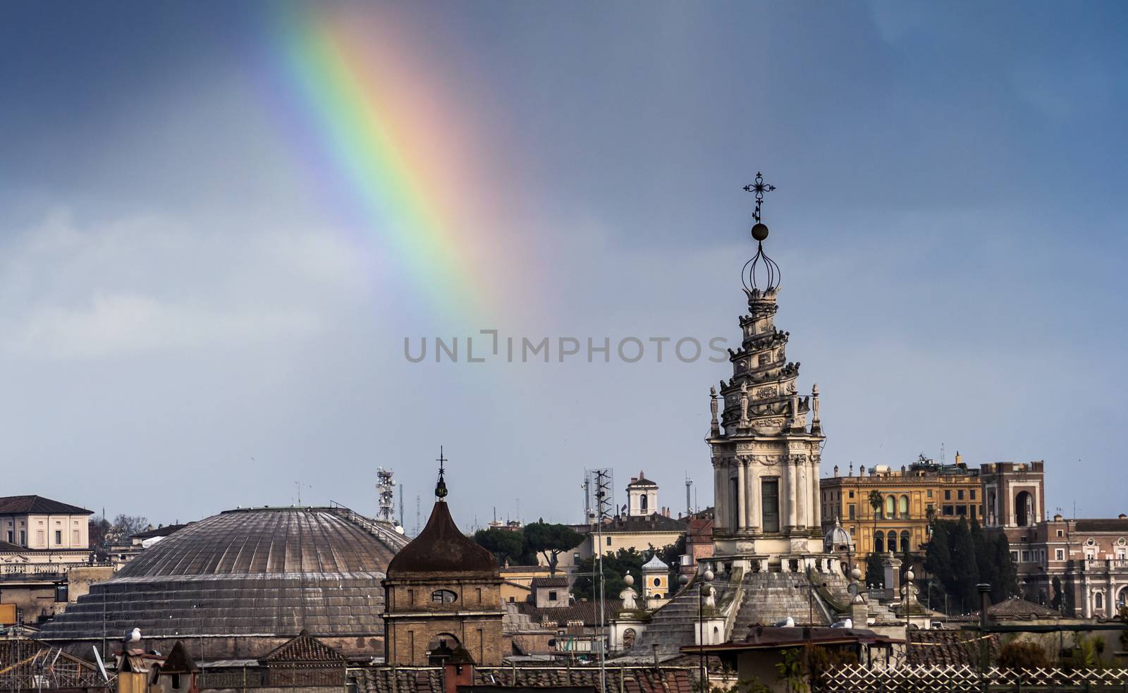 wonderful rainbow lights the sky over the roofs of Rome after a rainfall