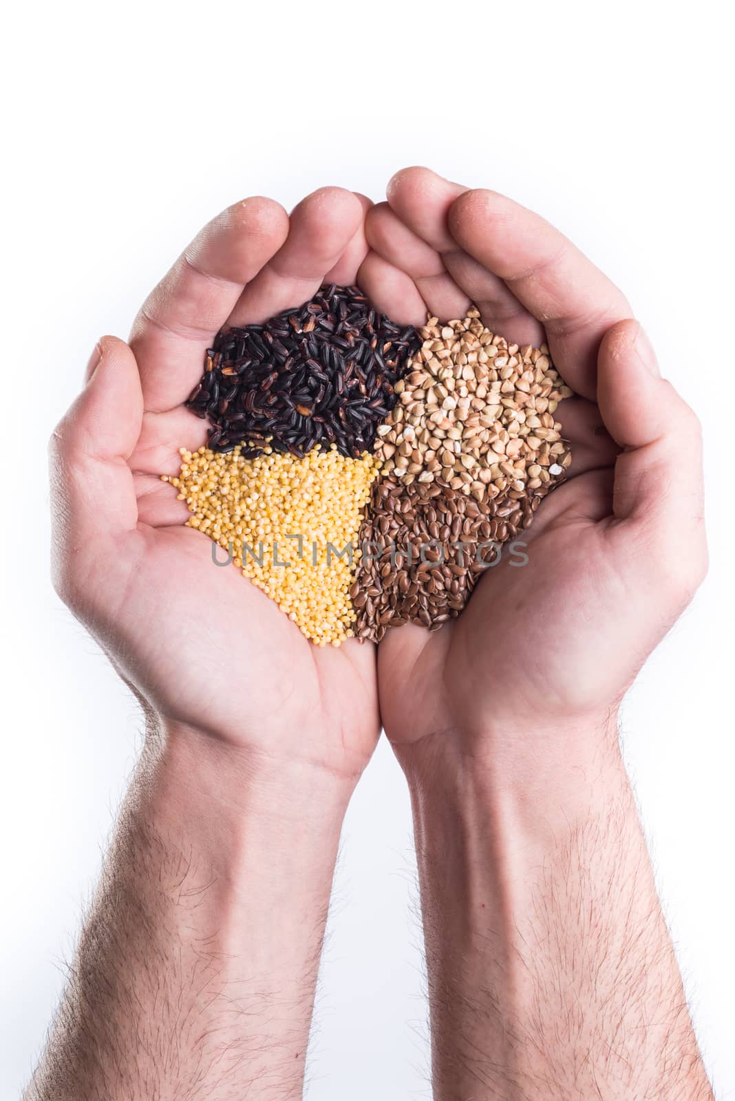 Man's hands holds gluten free coloured seeds and cereal
