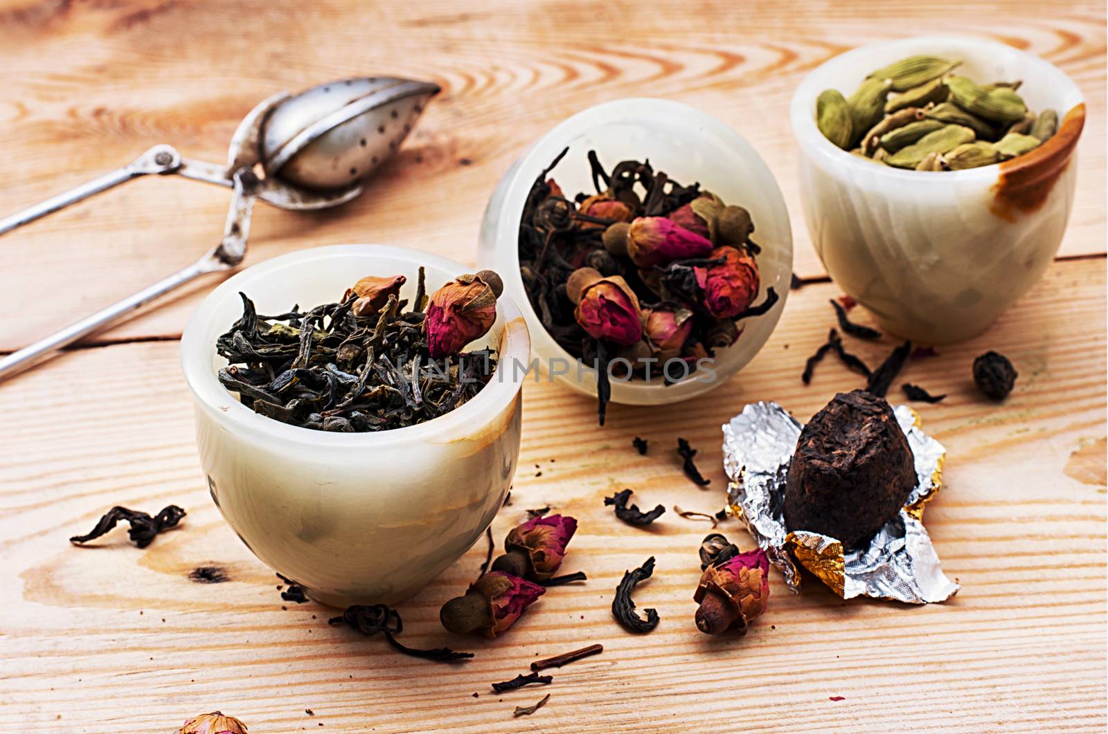 range of different varieties of tea leaves on wooden background