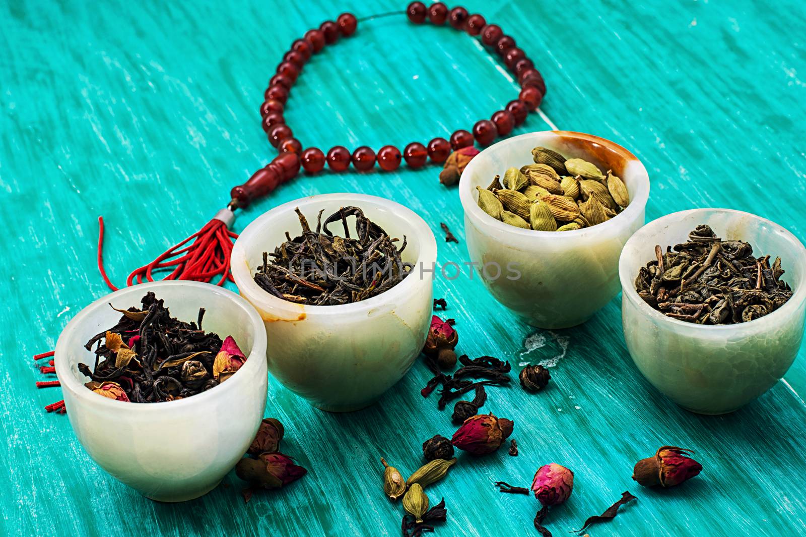 range of different varieties of tea leaves on wooden background