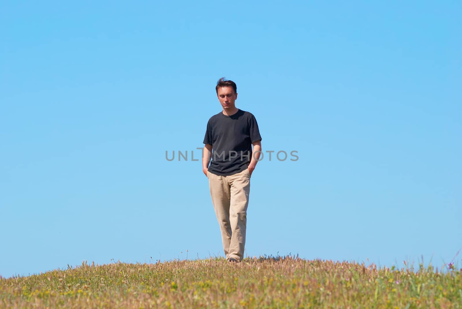 Young man on the grass field by vapi