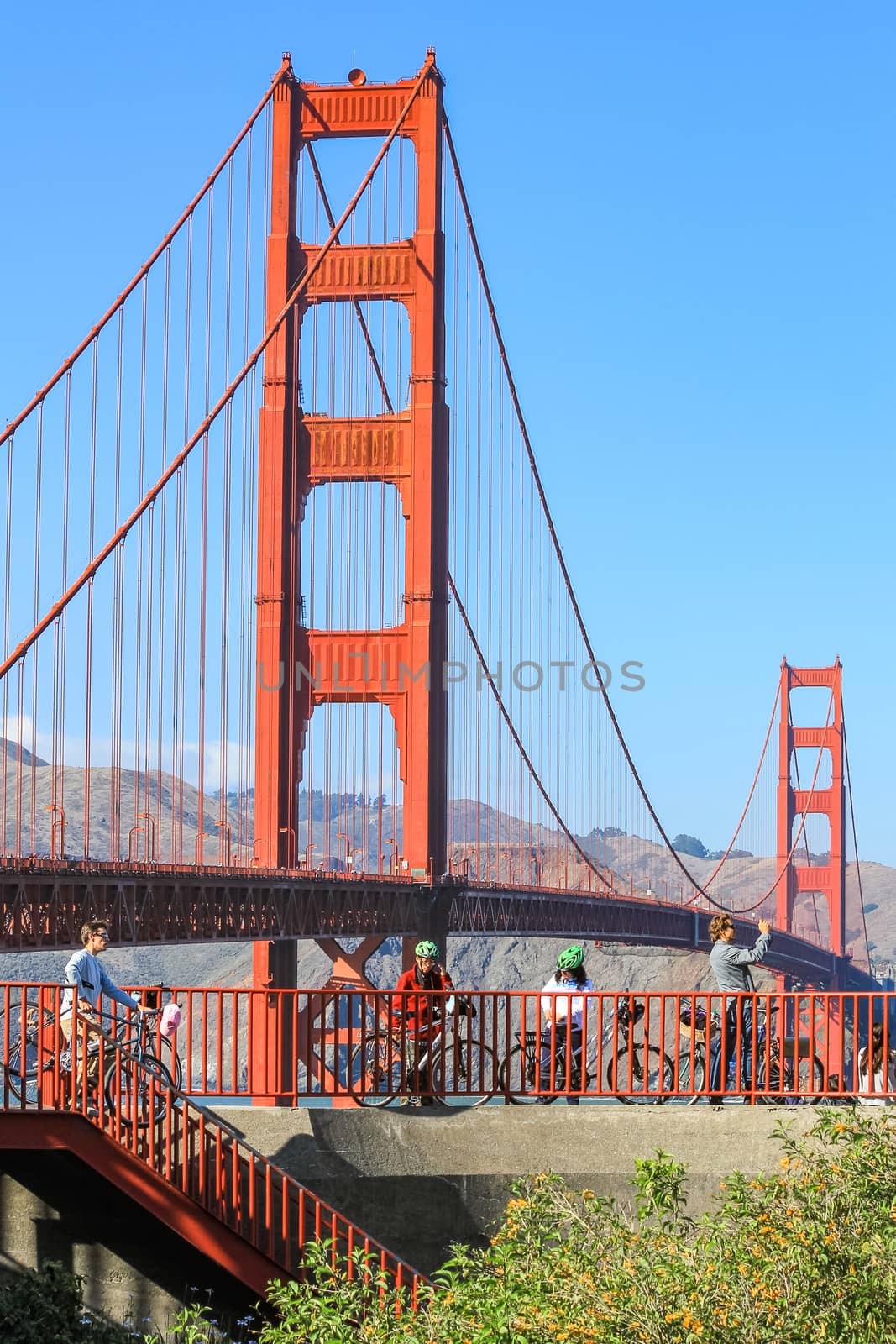 San Francisco, USA - October 8: People ride a bicycle with a Golden Gate bridge in the background on October 8, 2011 in San Francisco, USA.