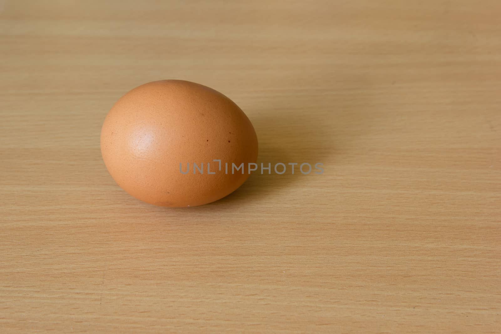 Chicken egg on the wooden table