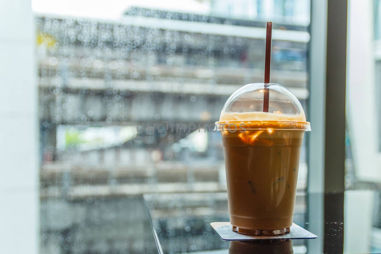 A cup of cold coffee in rainy day.