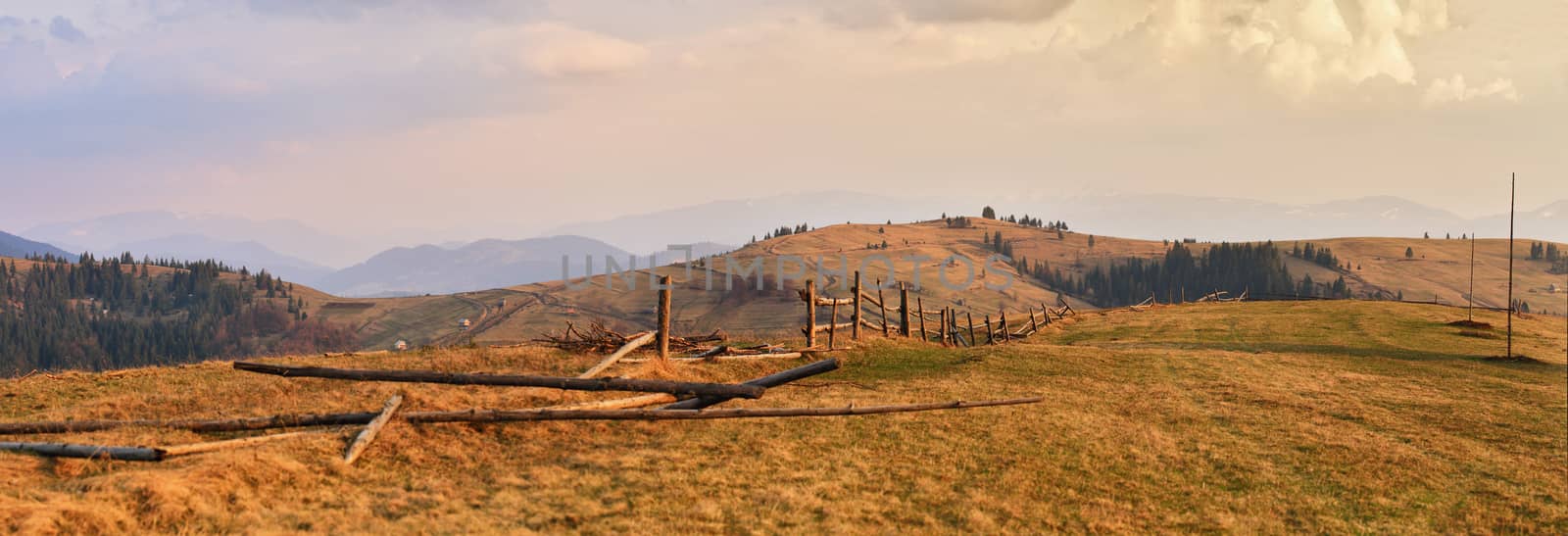 April evening in Carpathian mountains. Spring hills and fields.