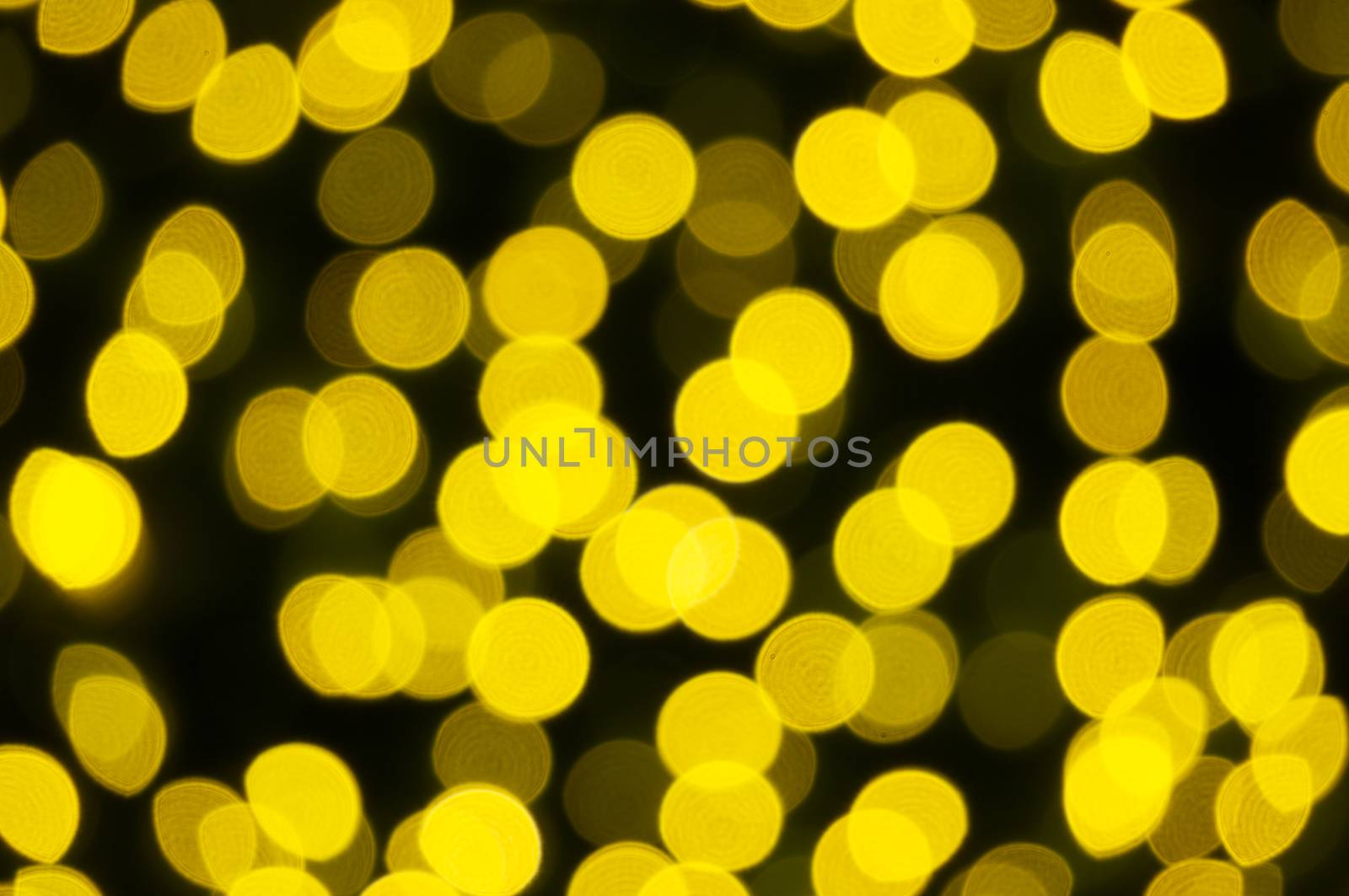 Defocused of glitter or yellow bokeh circle at night as background.