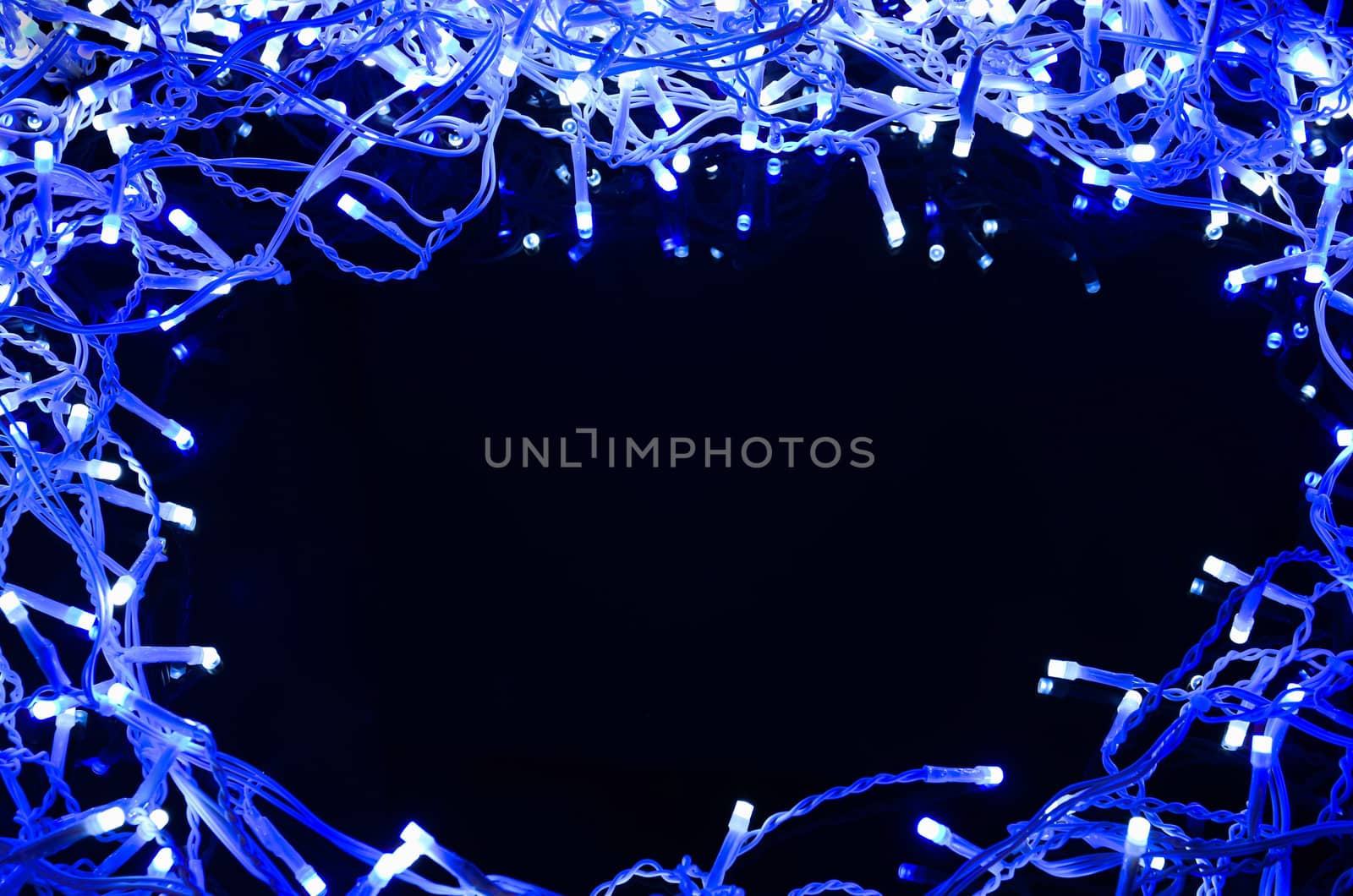 Christmas lights frame on black glass background with  space for your text. 

