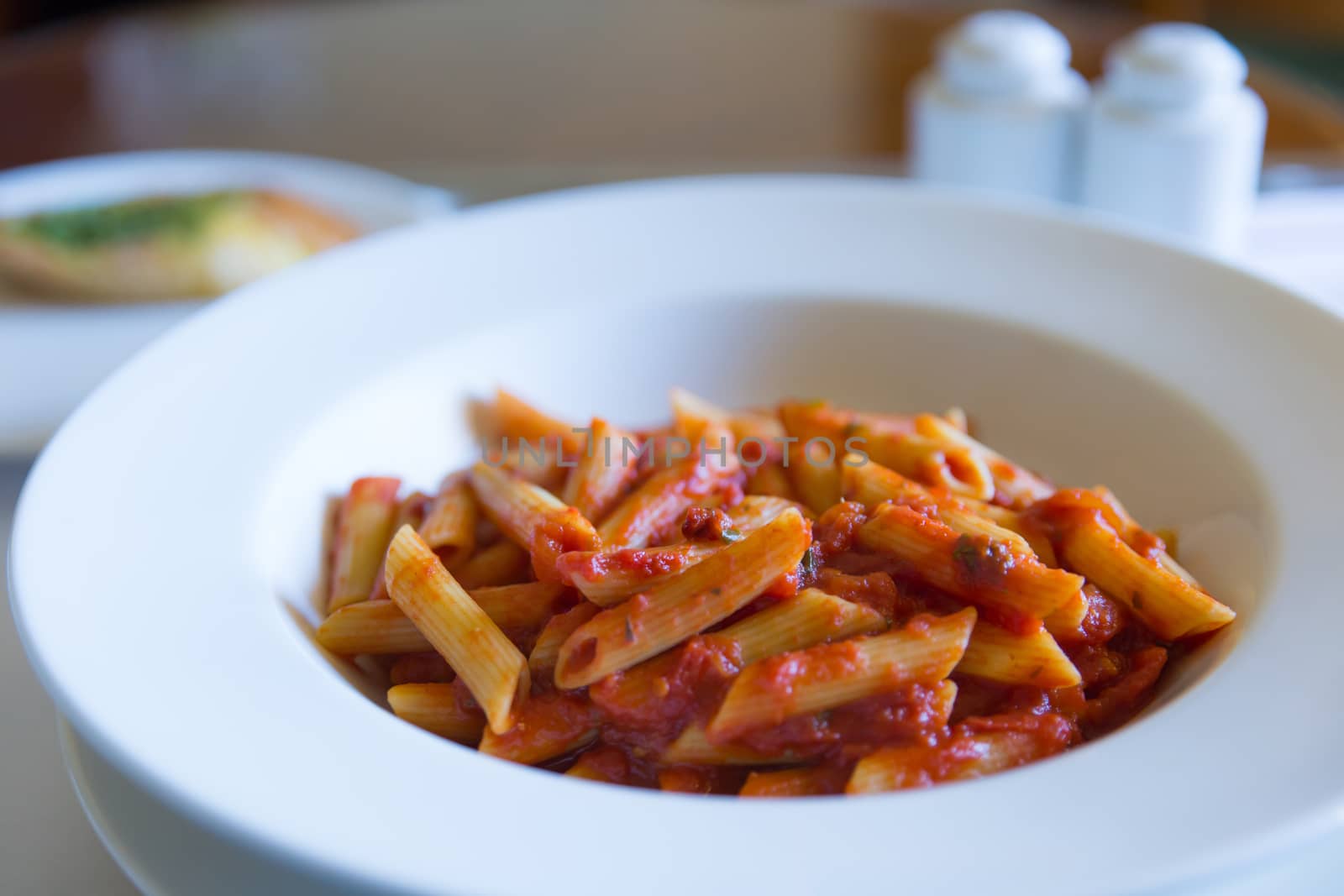 A plate of penne arrabbiata from a hotel room service