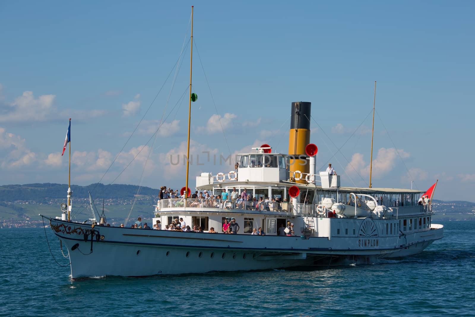 Yvoire, France - August 22, 2015: The Simplon passenger steamboat arriving in the medieval city of Yvoire, France.
