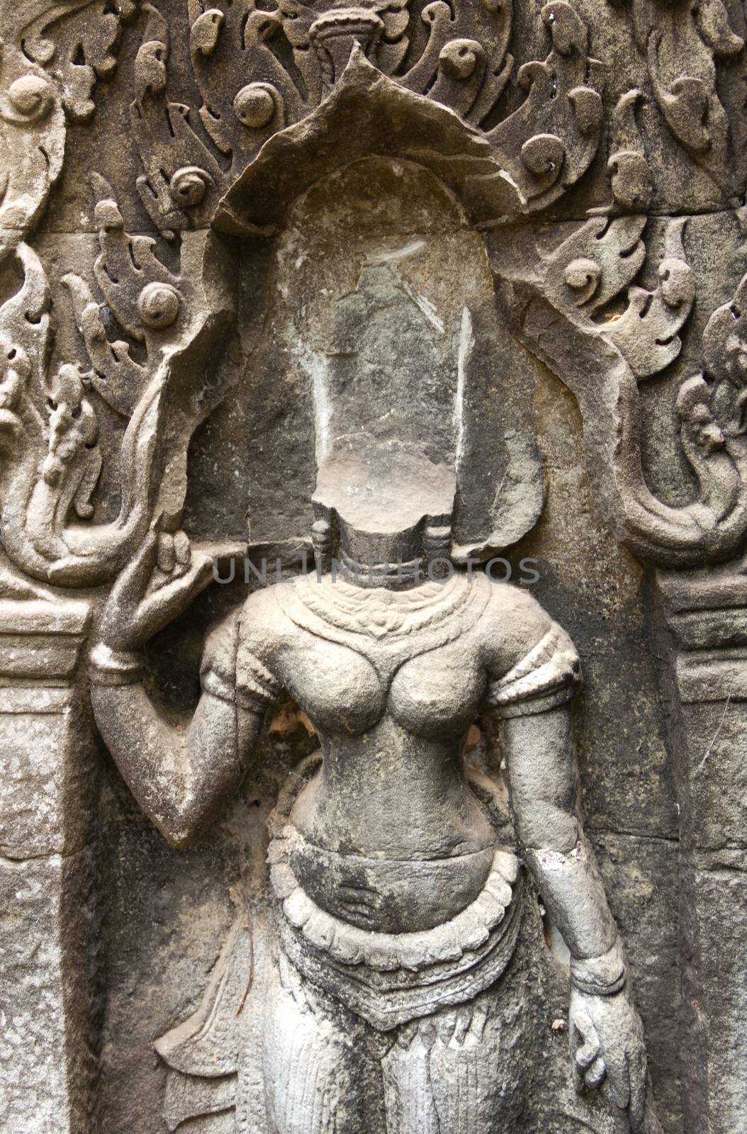 Bas-Relief at Ta Phrom temple showing a  Apsara without head which was stohlen