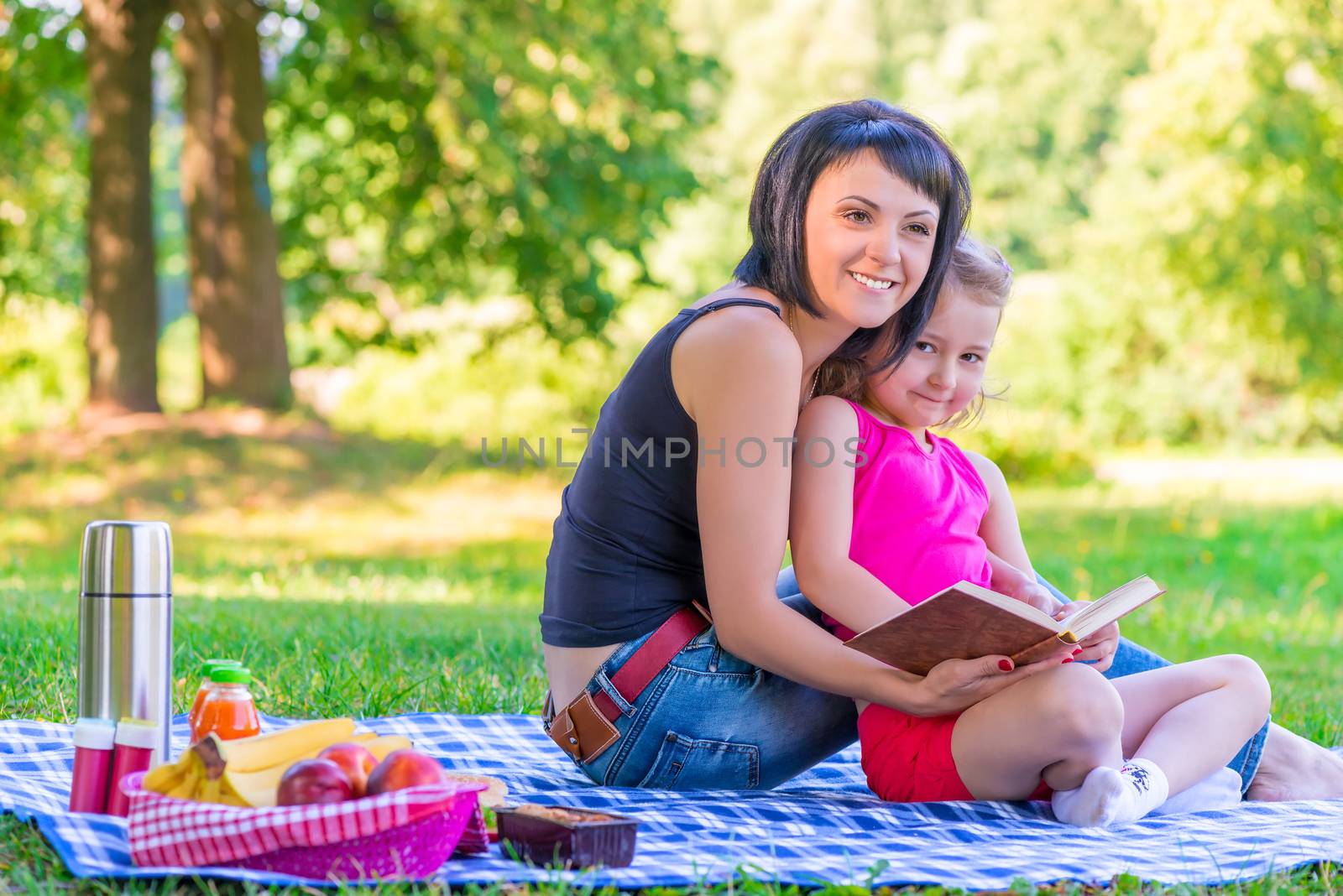 young mother with her daughter at a picnic