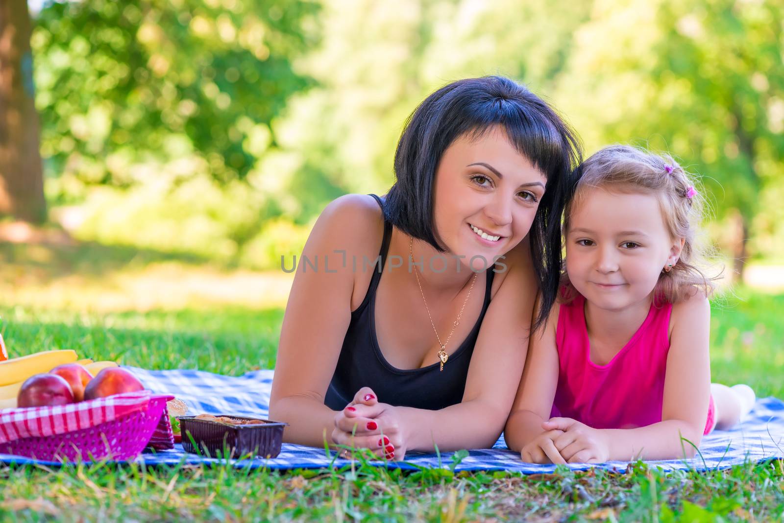 portrait of a smiling mother and her daughter on the lawn by kosmsos111