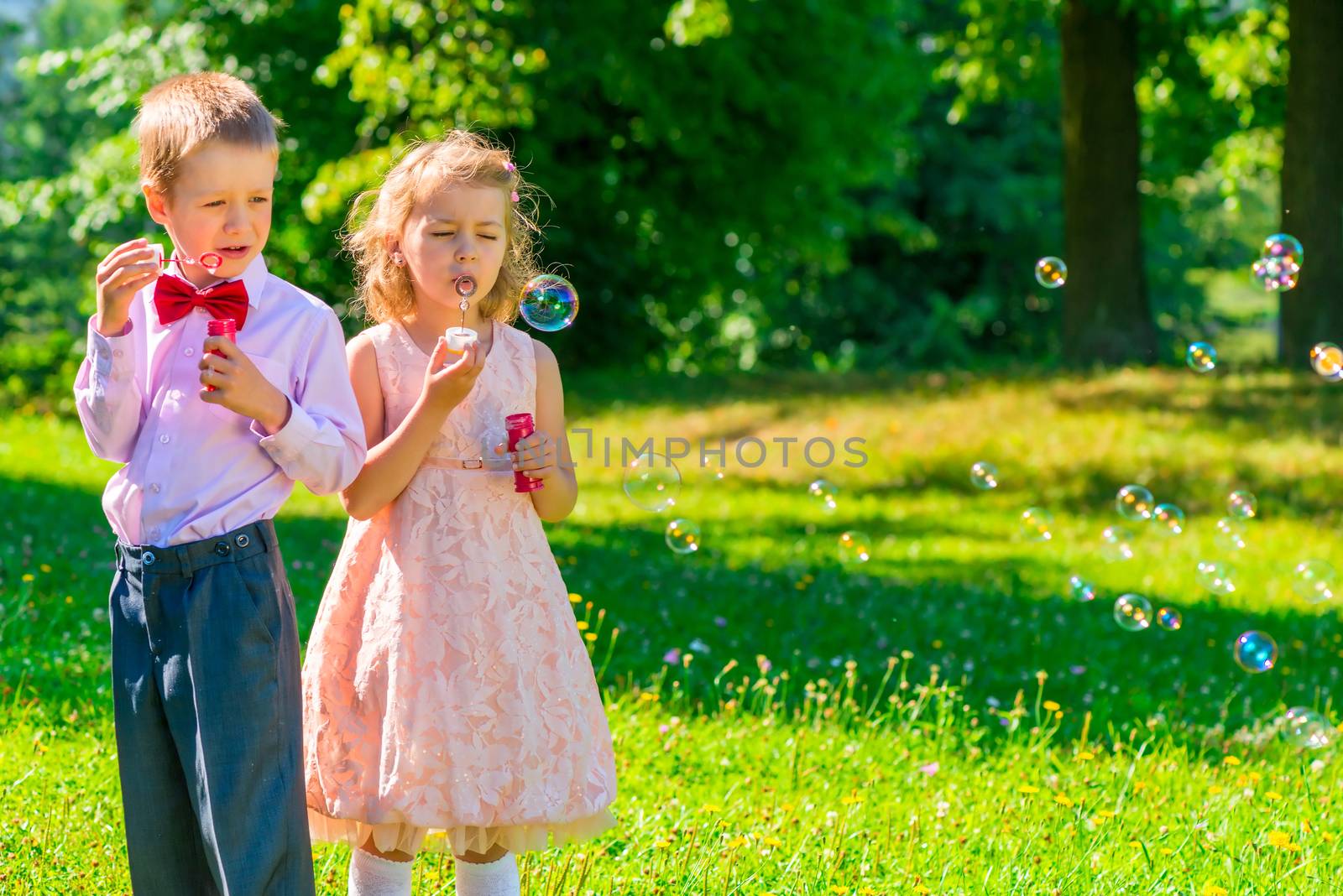 horizontal shot child with soap bubbles outdoors