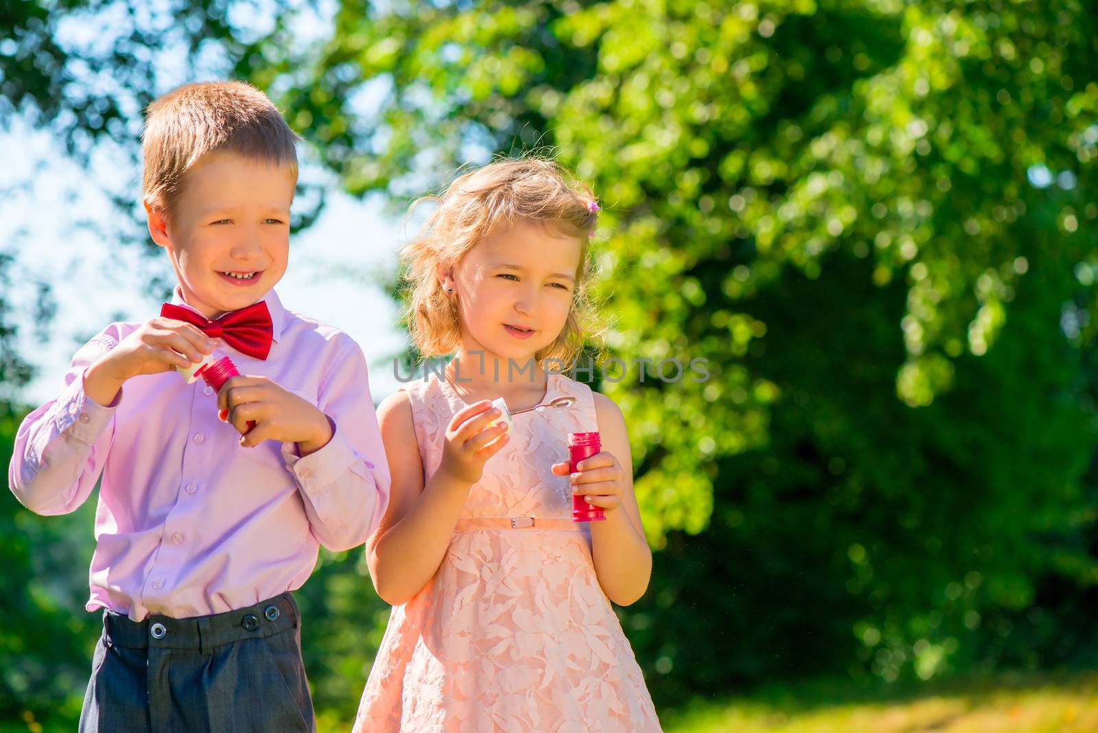 a boy and his girlfriend with soap bubbles in the park by kosmsos111