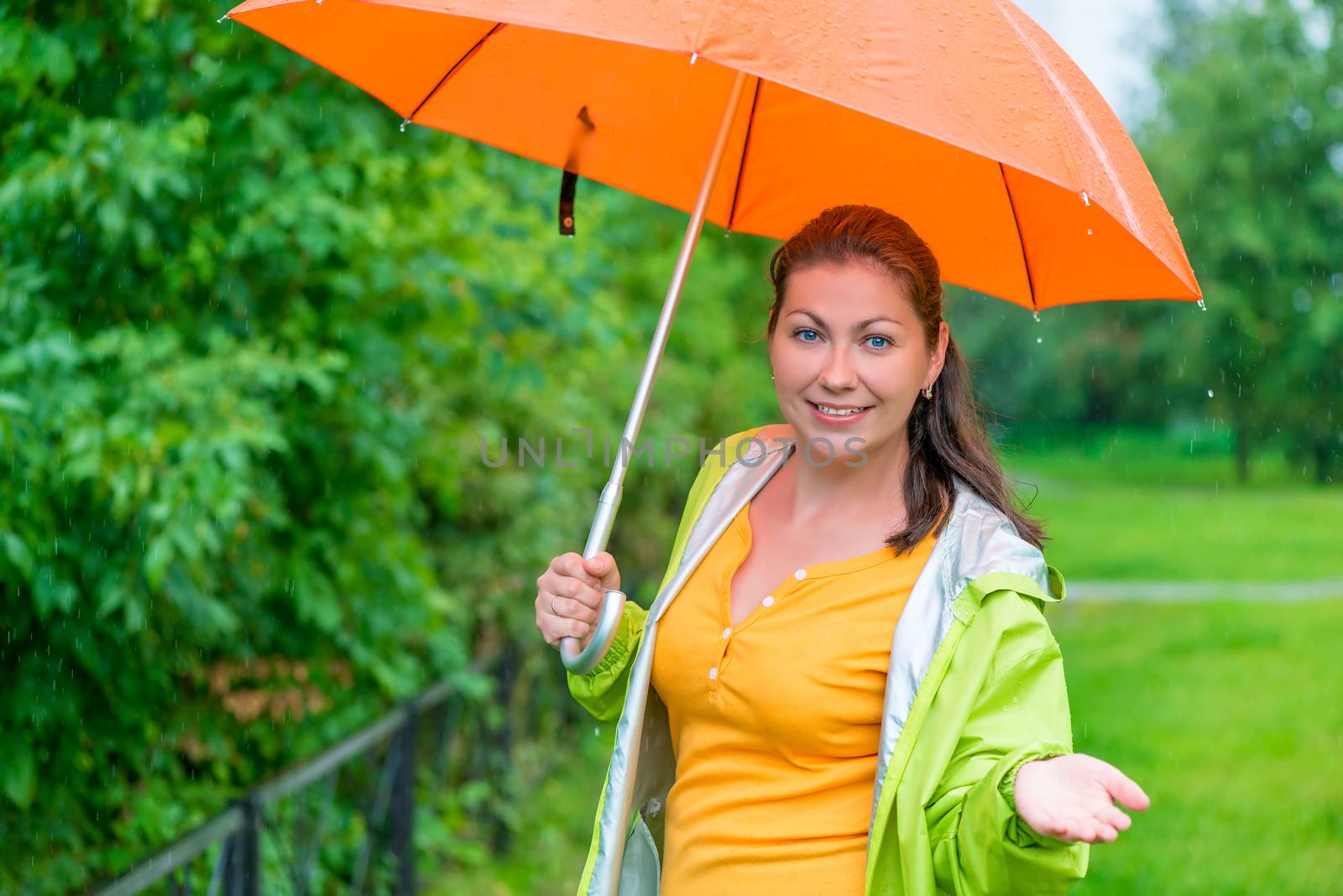 portrait of a girl with an umbrella in rainy weather