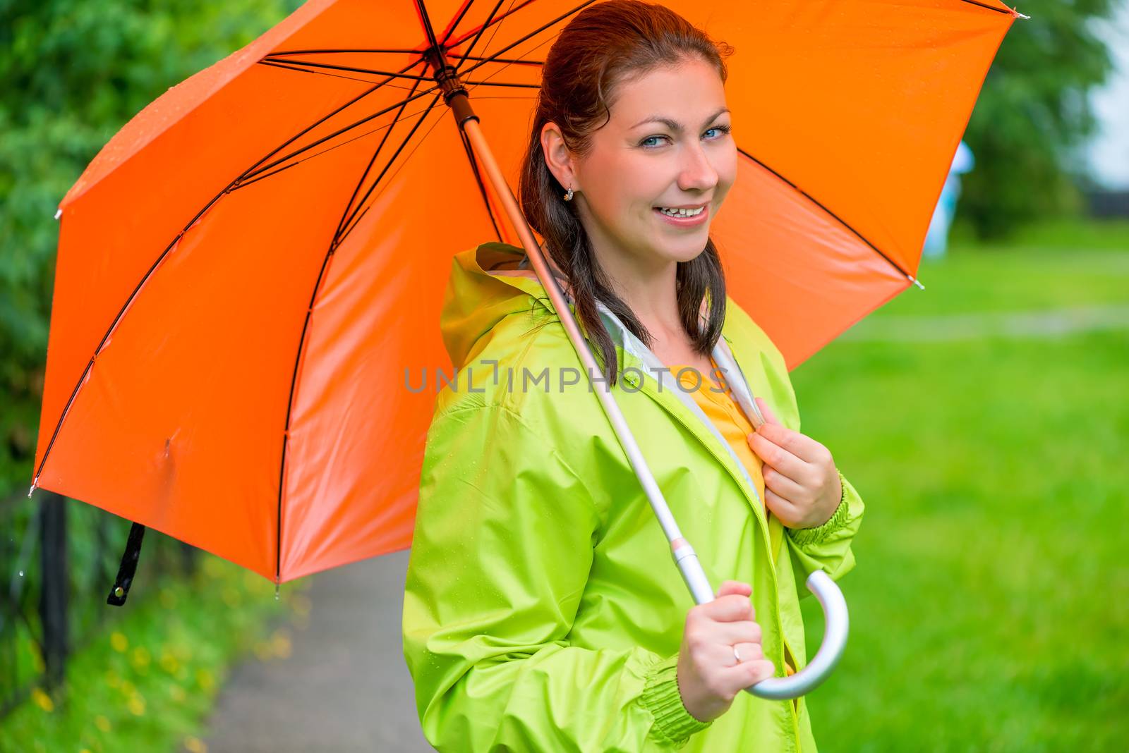 beautiful young brunette woman with an orange umbrella closeup by kosmsos111