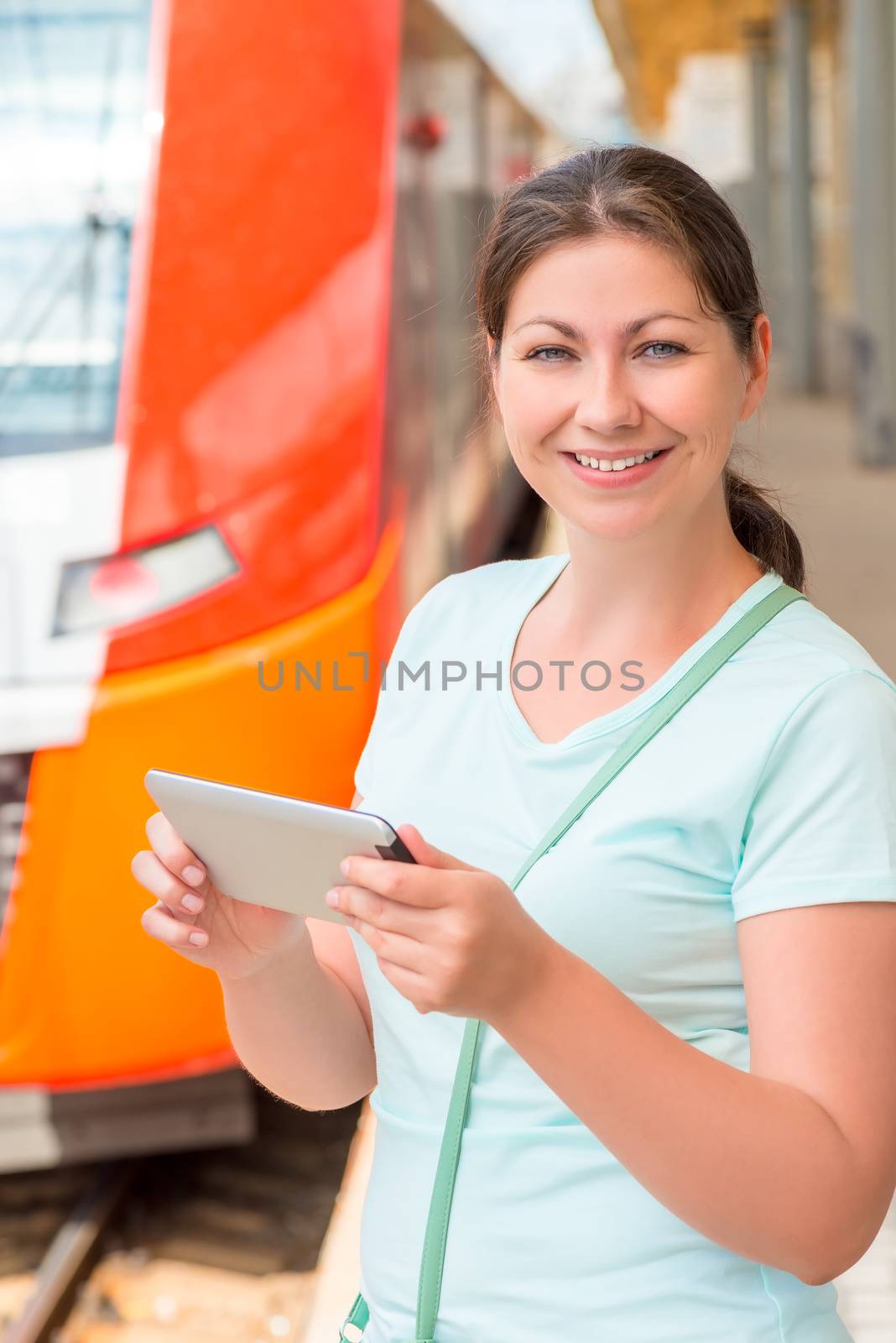 Girl with tablet waiting boarding the train by kosmsos111