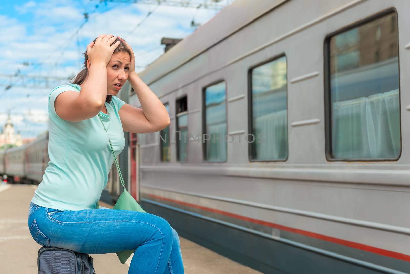 emotional woman looks at the departing train on which she was late