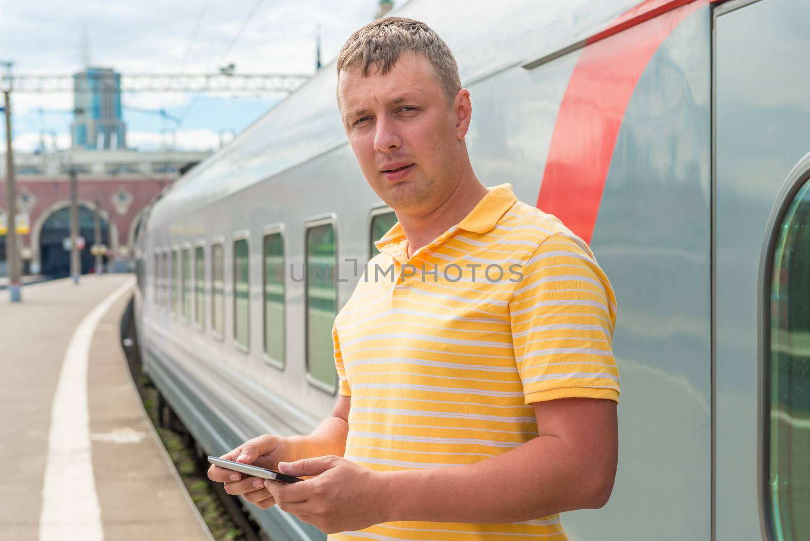 man in a yellow shirt at the railway station by kosmsos111