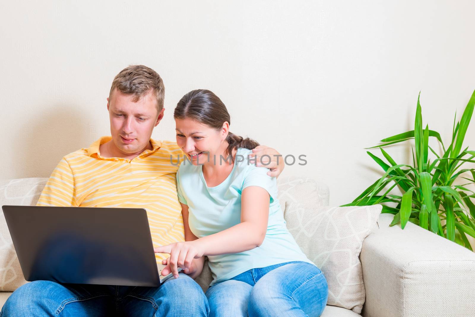 couple shopping online on a couch in the living room by kosmsos111