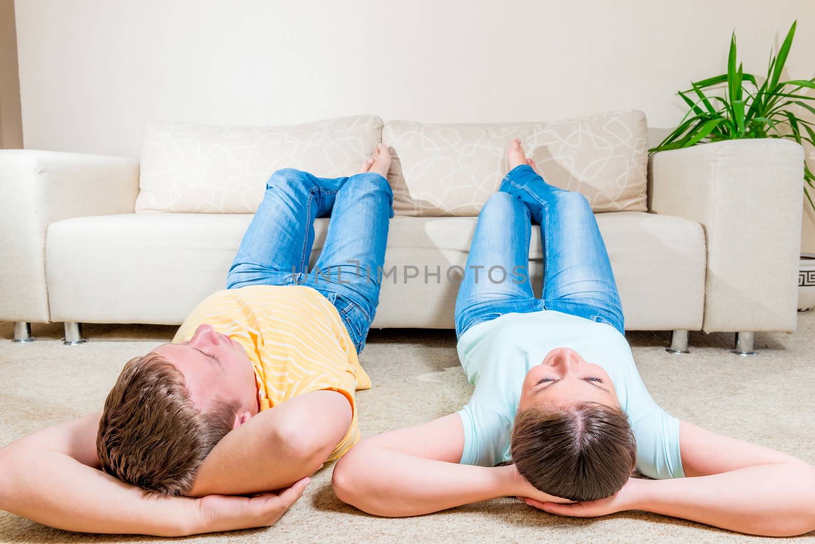Young couple dreaming about the future of lying on the floor in the living room