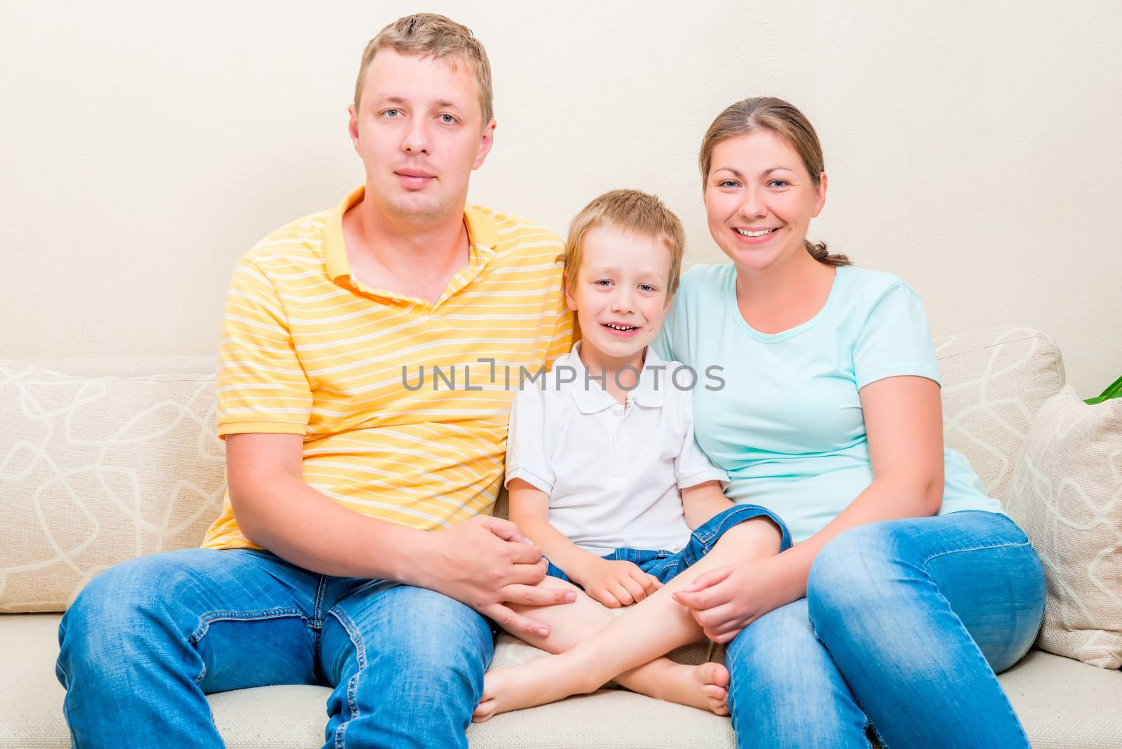 portrait of a happy family on the sofa in the living room by kosmsos111
