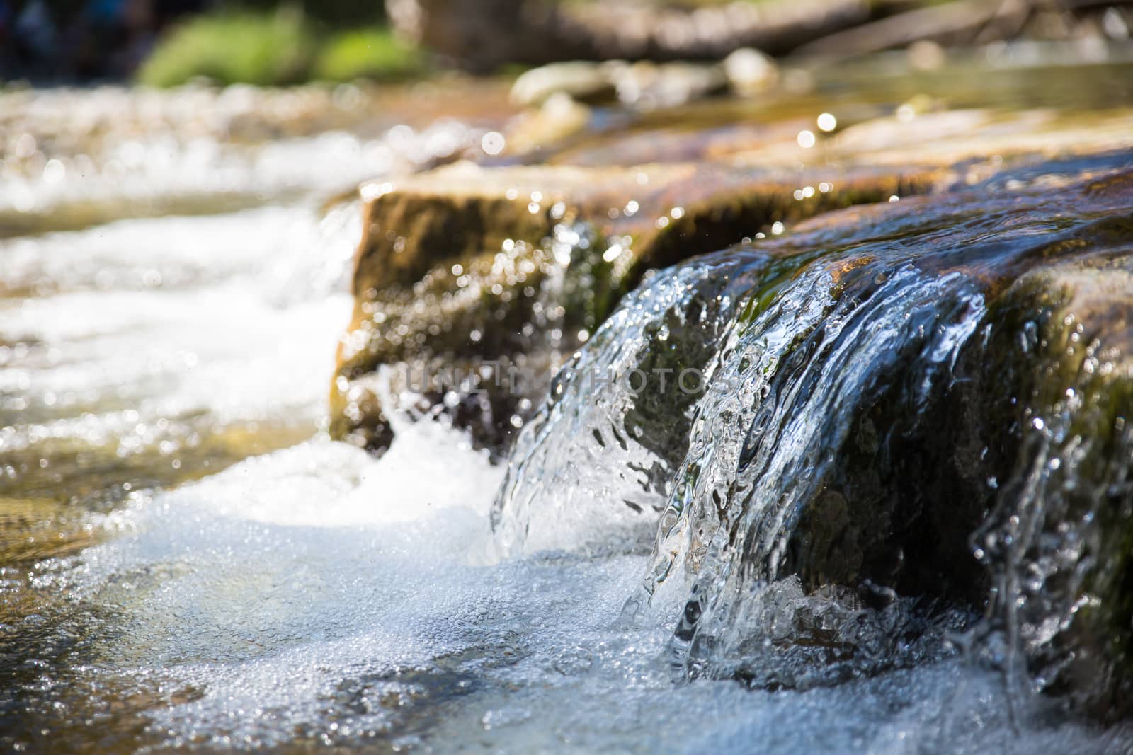 Small waterfall in a torrent, shallow depth of field