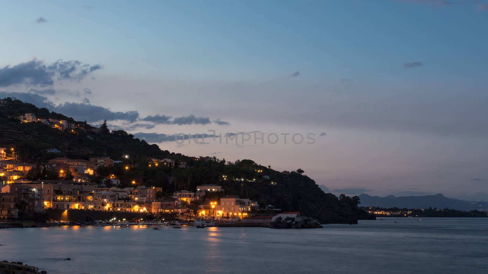 Waterfront street and old buildings by night.