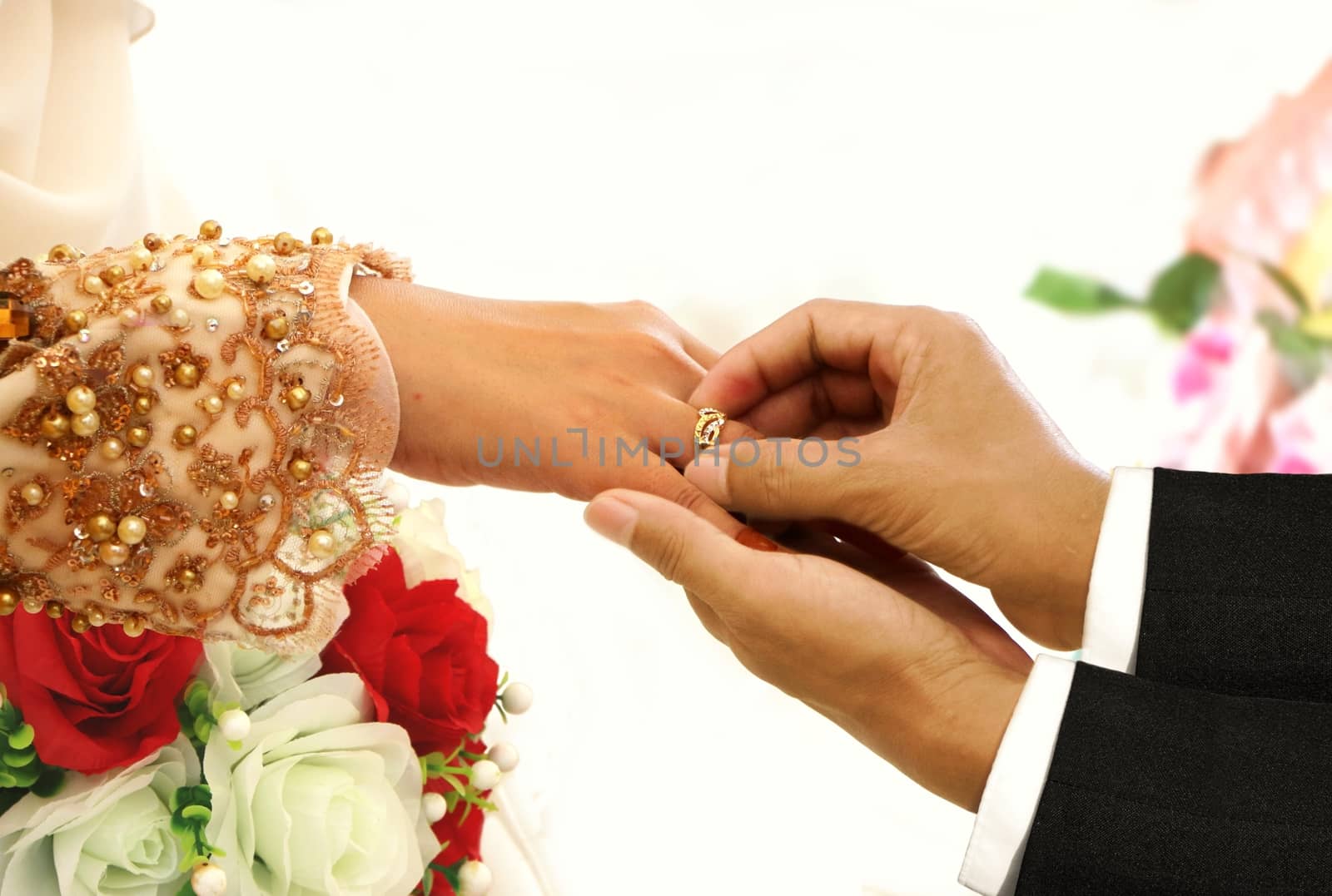 Wedding ring exchange ceremony between bride and groom